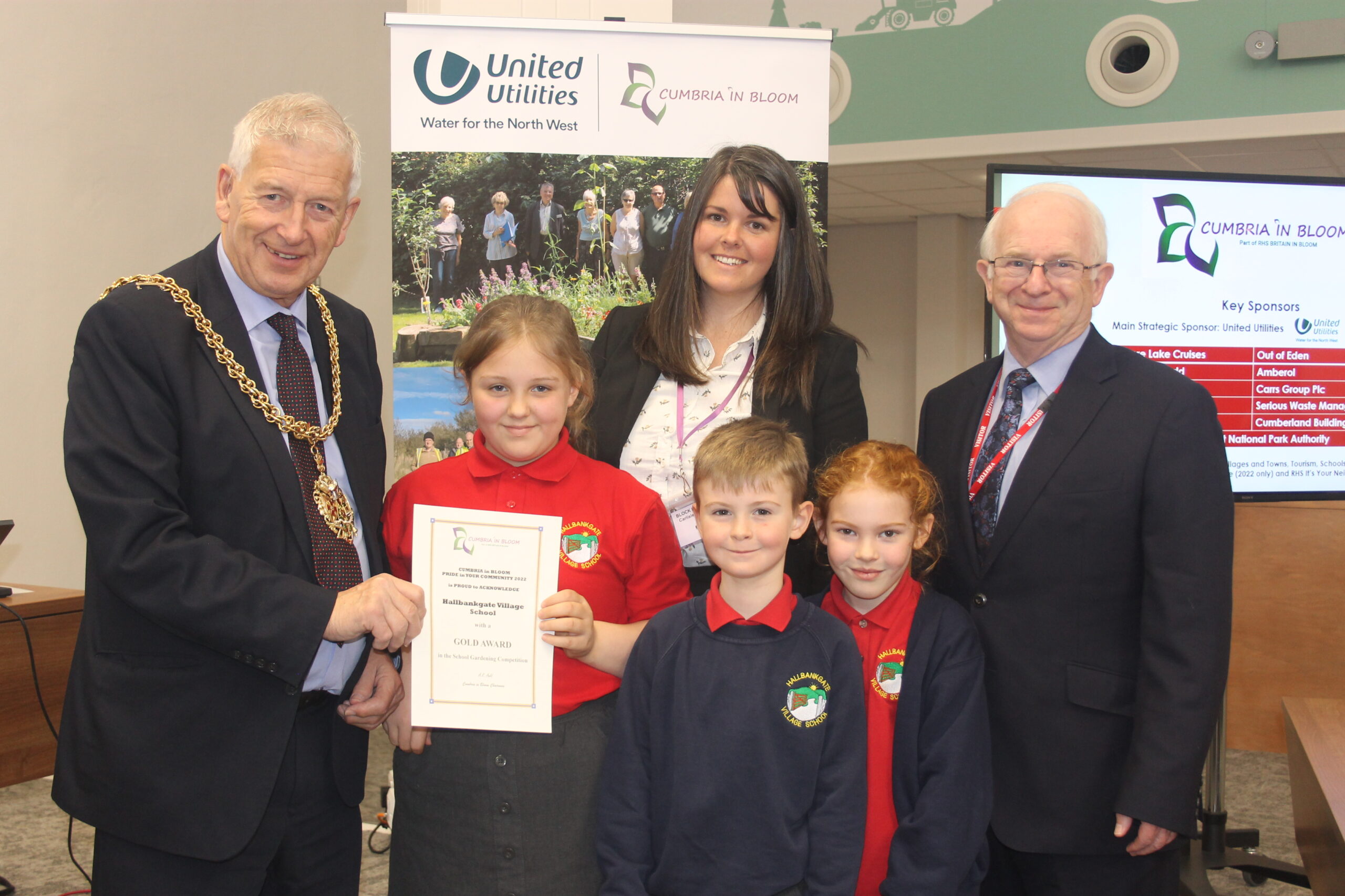 Mayor of Carlisle, Mike Mitchelson and Hayden Spedding of Cumbria in Bloom present Hallbankgate Village School with their Gold award